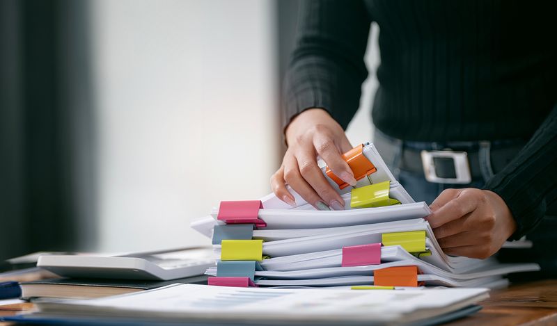 Pile of Test Management Folders with colourful clips.